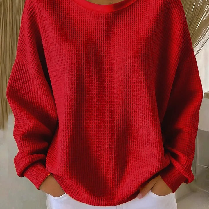 Side profile of the Soraya knitted wide collar sweater, highlighting the gentle drape and visible knit texture.