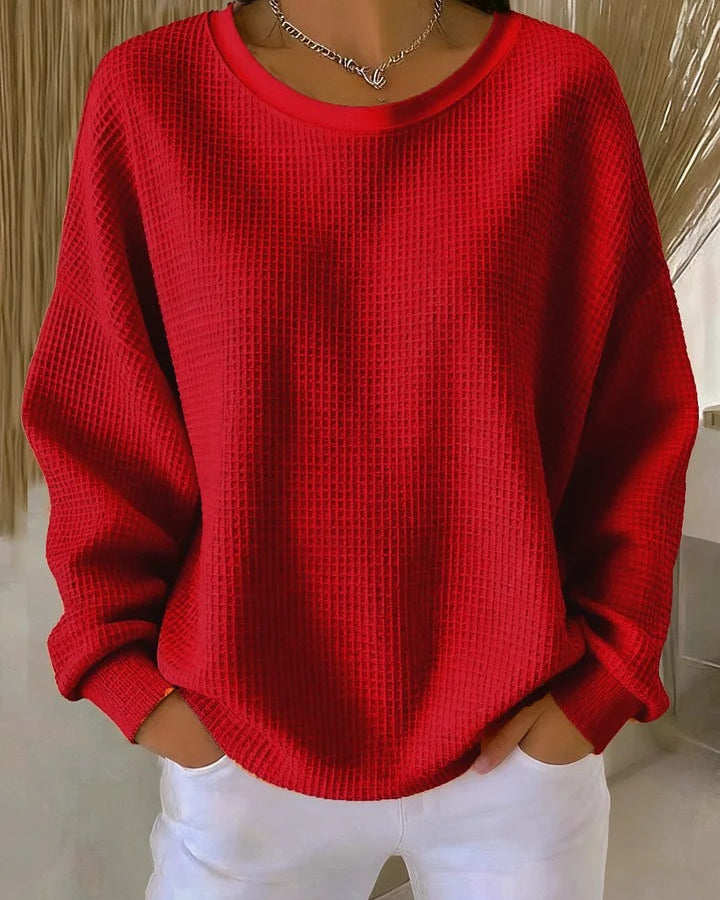 Side profile of the Soraya knitted wide collar sweater, highlighting the gentle drape and visible knit texture.