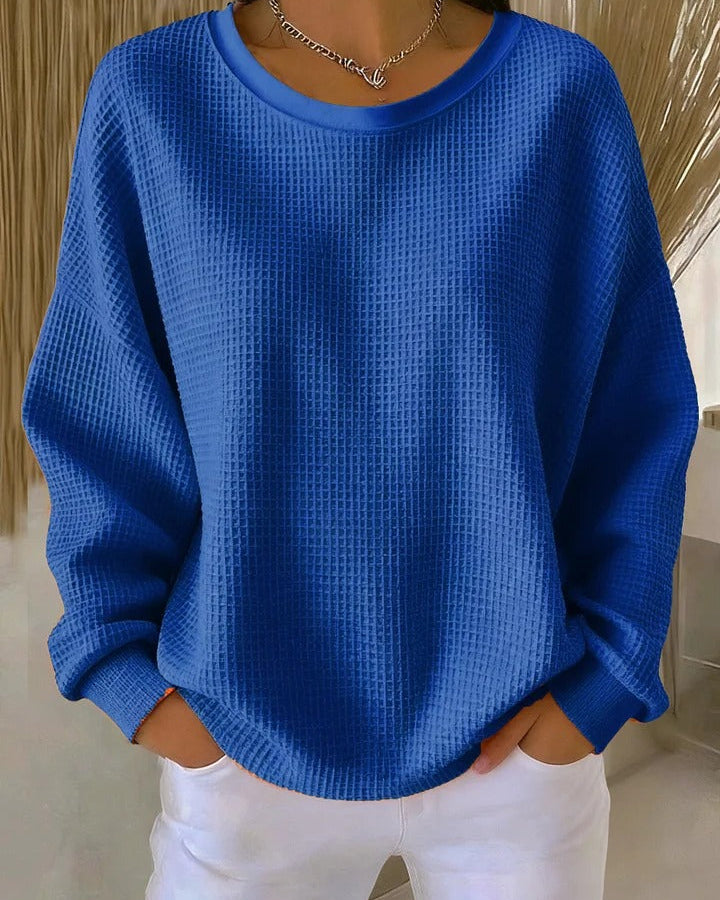 Back view of the Soraya knitted wide collar sweater, showing the simple hem and overall relaxed silhouette.