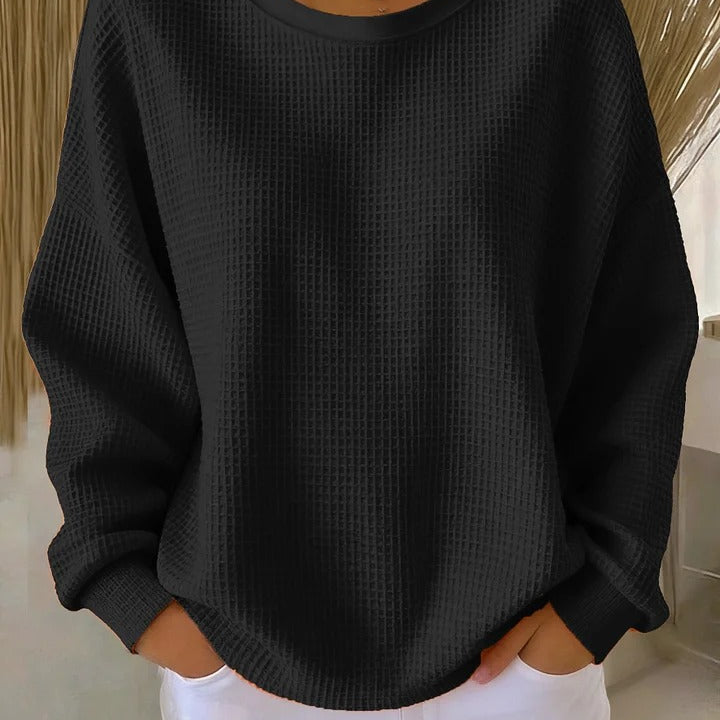 Detailed shot of the sleeve cuff and hem of the Soraya knitted wide collar sweater, showcasing the finish.