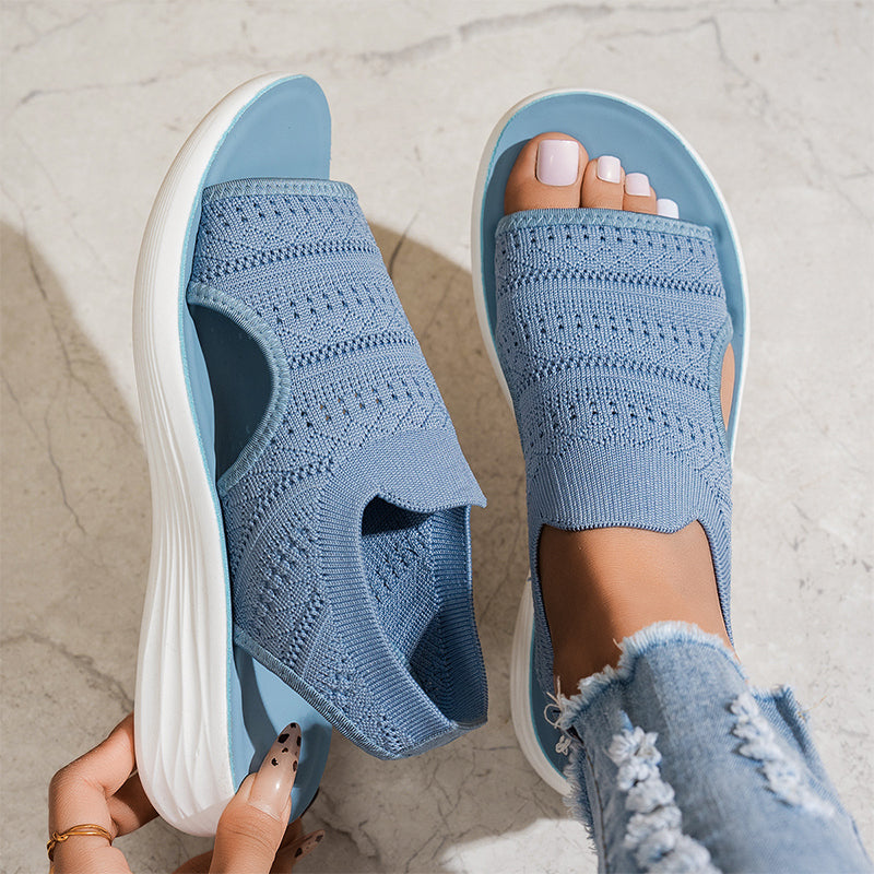 Overhead shot of gray knit sandals, displaying the full shape and ergonomic footbed for comfort.