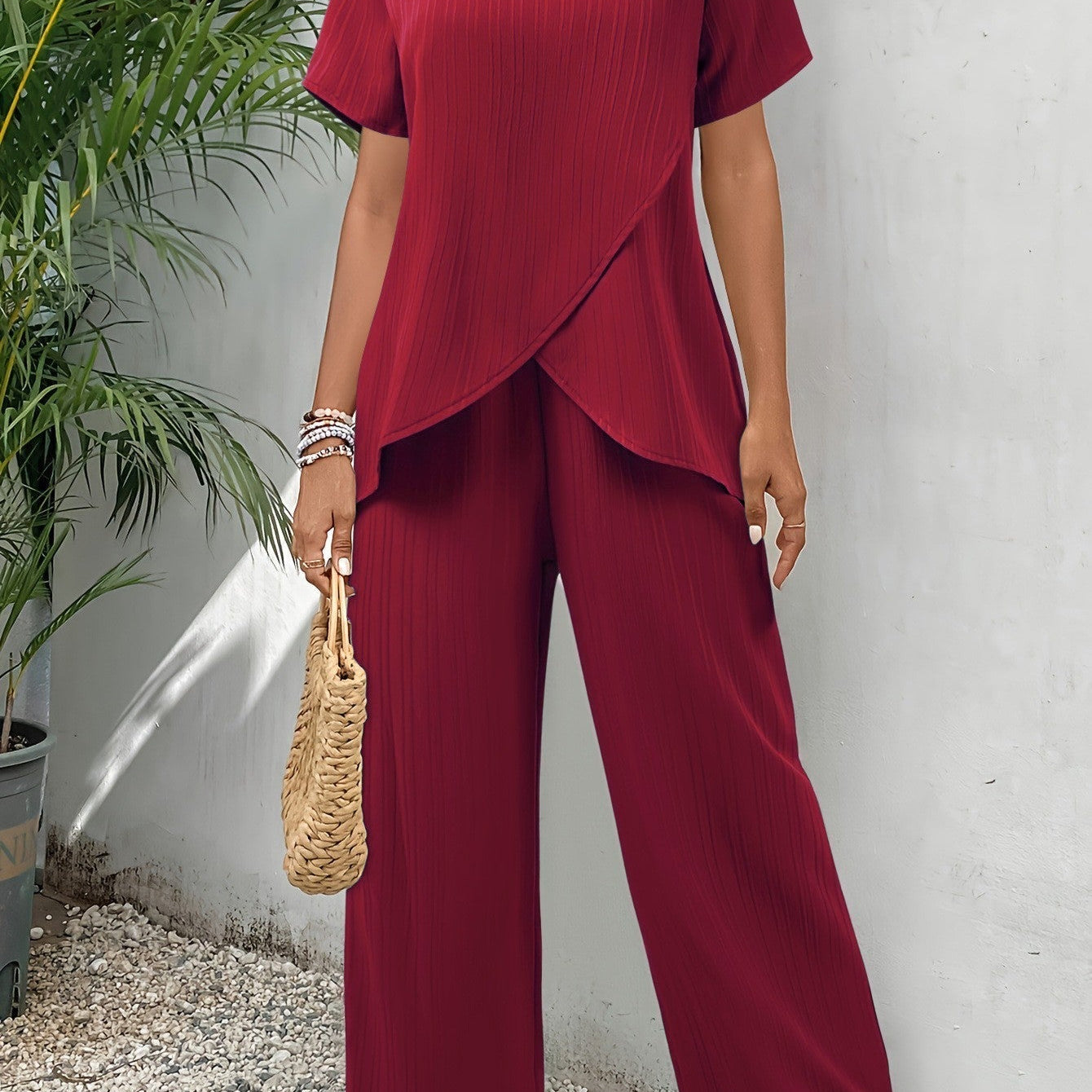 Close-up of the breathable fabric texture on elegant green wide-leg pants.
