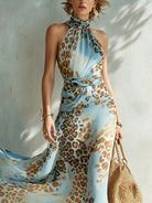 Side profile of a women's animal print maxi dress, illustrating the defined waist and stylish high side slit.