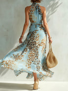 Back view of the tie-fastened open design on a graceful animal print maxi dress, emphasizing adjustable comfort.