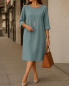 Woman enjoying a stroll in the yellow midi dress, illustrating its lightweight feel and suitability for various occasions.