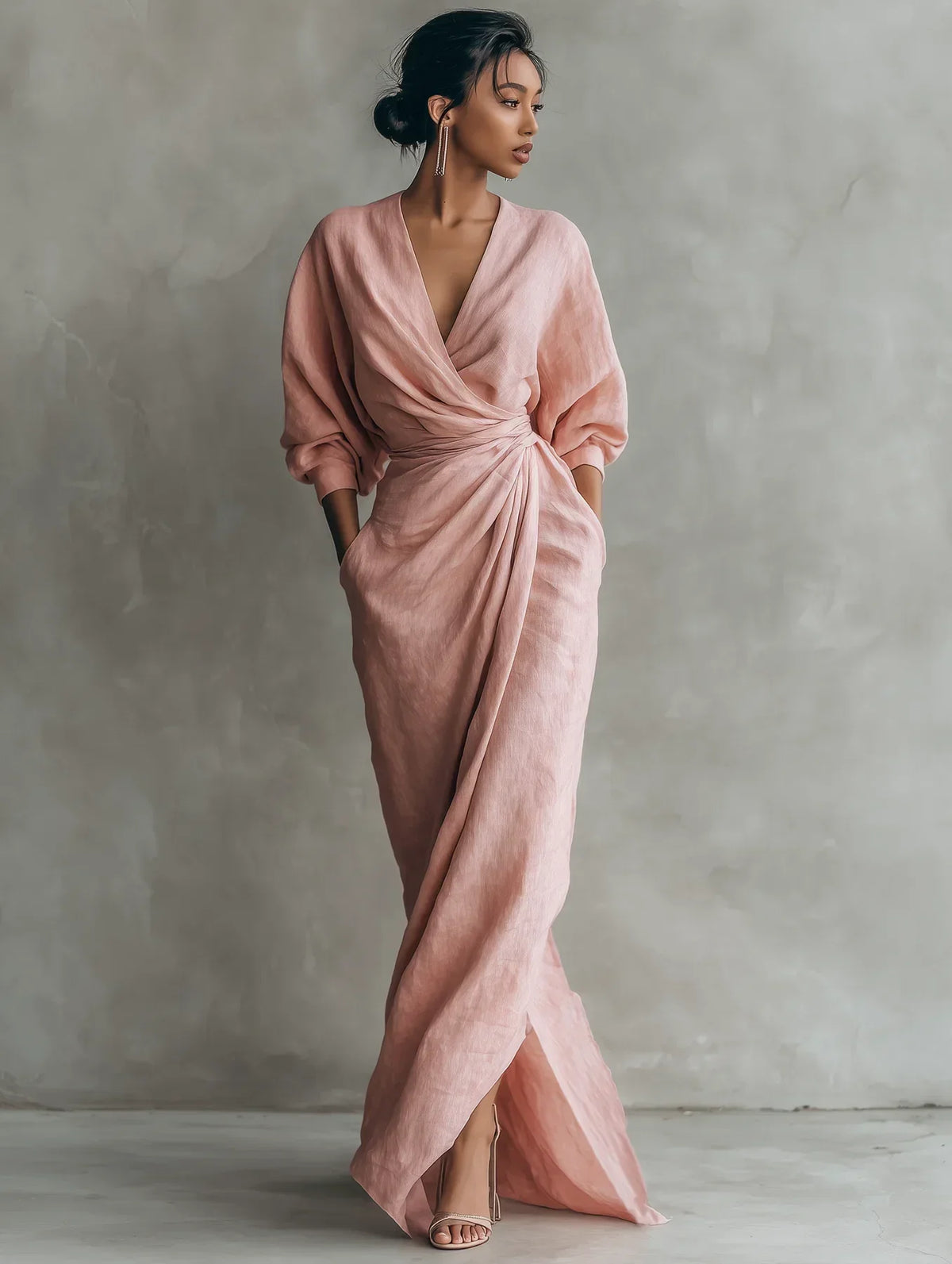 Side profile of the brown V-neck maxi dress, highlighting the fluid drape of the fabric and three-quarter blouson sleeves.