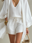 White casual shorts paired with simple accessories, showcasing an effortless look for semi-formal events.