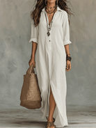 Model in the blue long sleeve maxi dress, styled with layered necklaces for an effortlessly chic appearance.