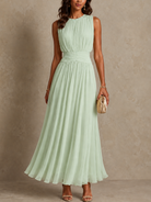 Detailed view of the round neckline and sleeveless cut on the versatile occasion dress, perfect for warm rooms.