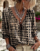 Green Fiona blouse, folded neatly to show its compact and travel-friendly design.