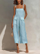 Back view of the light blue wide-leg jumpsuit, emphasizing the clean lines and comfortable drape of the garment.