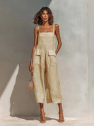 Close-up detail of the breathable linen-blend fabric and the practical patch pocket on the beige jumpsuit.