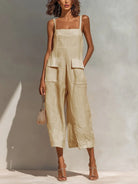 Full-length front view of the beige Faylinn jumpsuit, showcasing its wide-leg silhouette and square neckline.
