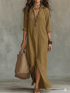 The black long sleeve maxi dress gracefully draped on a hanger, highlighting its fluid, bohemian nature.