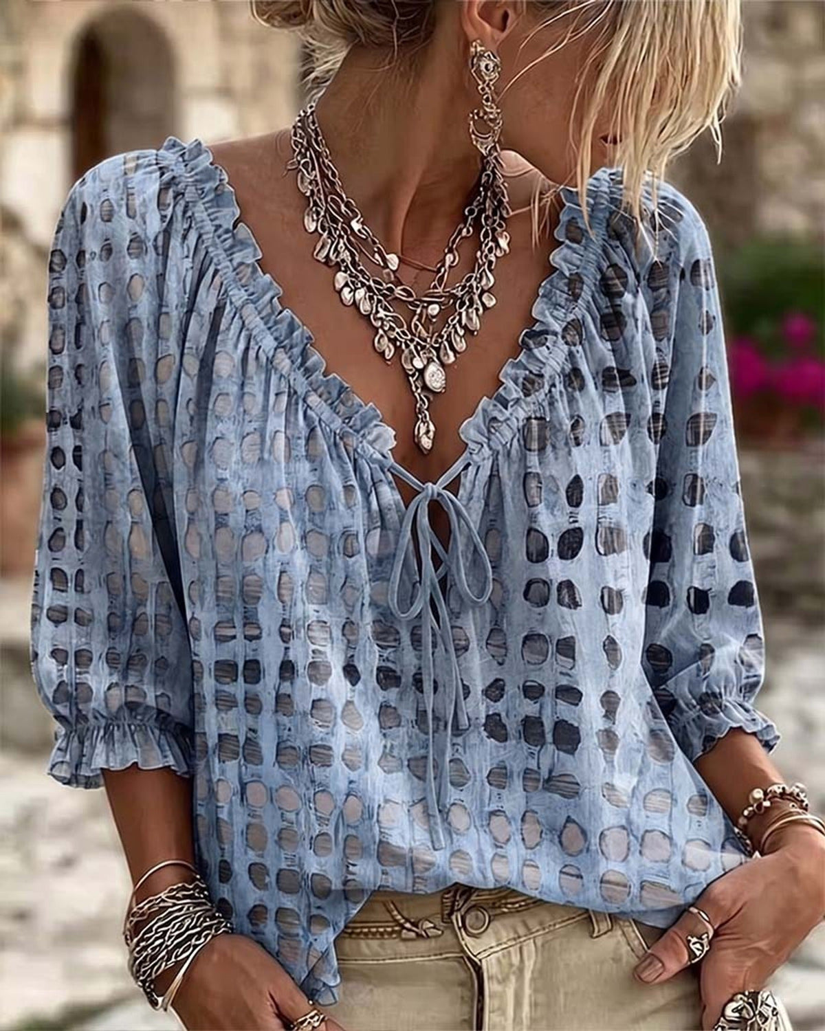Black boho print blouse, capturing the soft flow of the fabric as if in motion.