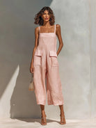 Model walking confidently in the pink Faylinn wide-leg jumpsuit, capturing its fluid movement and chic design.