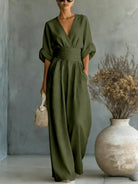 Close-up of the V-neckline on a yellow jumpsuit, showing the refined feminine touch and detail.