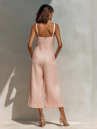 Side profile of a model wearing the elegant light blue jumpsuit, highlighting the relaxed fit and ankle-length design.