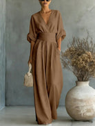 Burgundy jumpsuit from a slightly elevated angle, highlighting the full length and elegant wide-leg flow.