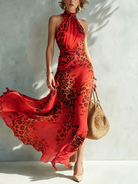 Detailed shot of the blended leopard print texture on the elegant twisted halter maxi dress, catching the light.