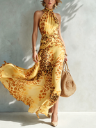 A women's animal print maxi dress in a rich purple hue, presented in a sophisticated setting for special occasions.