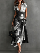 Model walking gracefully in the blue abstract print wrap maxi dress, showing the elegant flow of the skirt.