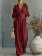 Pink wide-leg jumpsuit, perfect for festive occasions, captured in a dynamic and stylish pose.