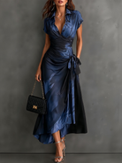 Model posing in a white abstract print wrap maxi dress, capturing movement and sophisticated style.