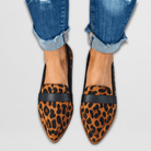 Leopard print suede loafers displayed casually, emphasizing their unique pattern and sophisticated appeal.