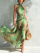 A woman wearing a vibrant red animal print maxi dress, styled for a glamorous evening event or celebration.