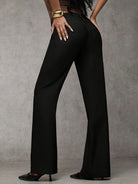 Side profile of a model wearing beige Indira trousers, highlighting the flowing silhouette and comfort.