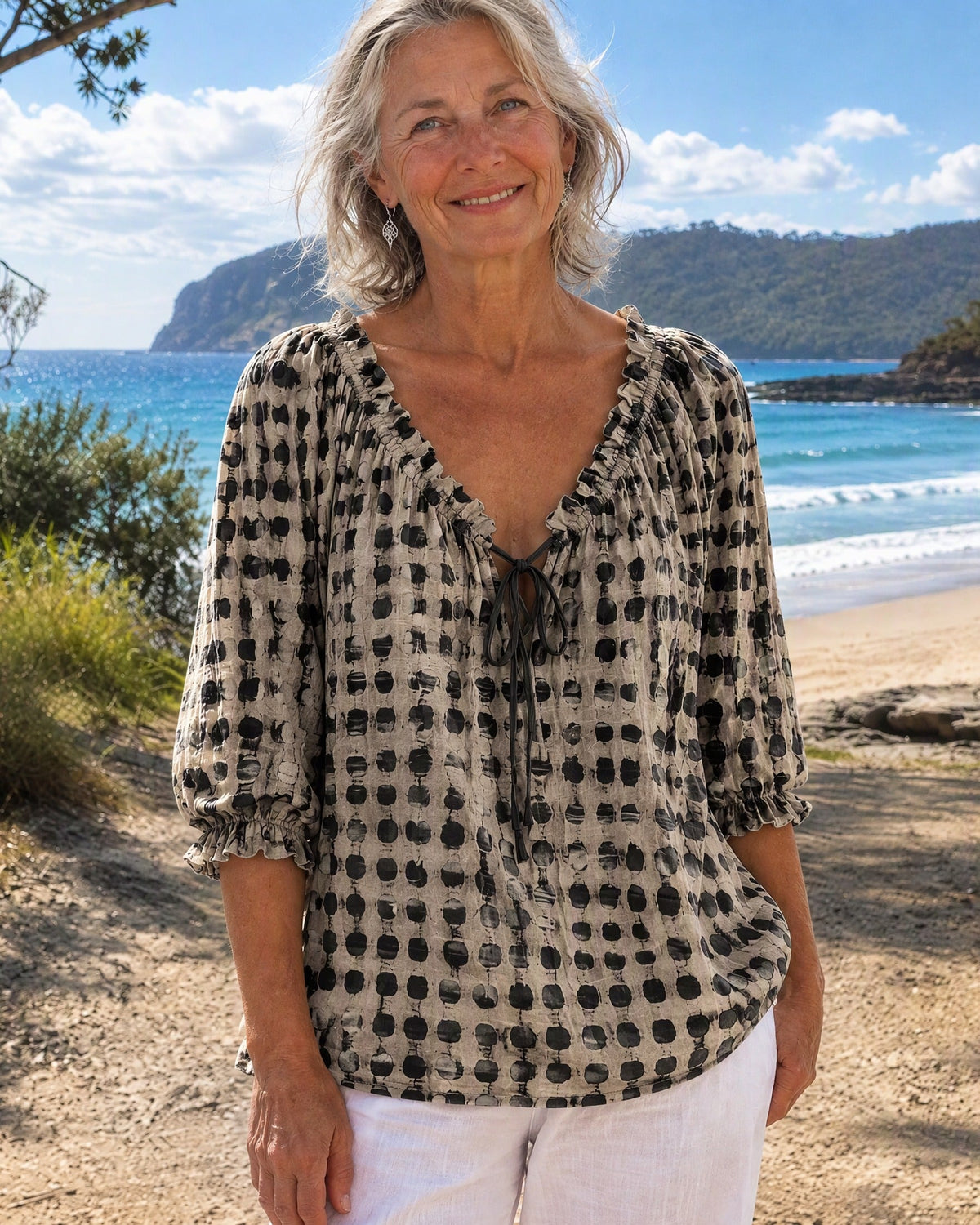 Black boho print blouse, photographed from the side, demonstrating its flowing drape and relaxed charm.