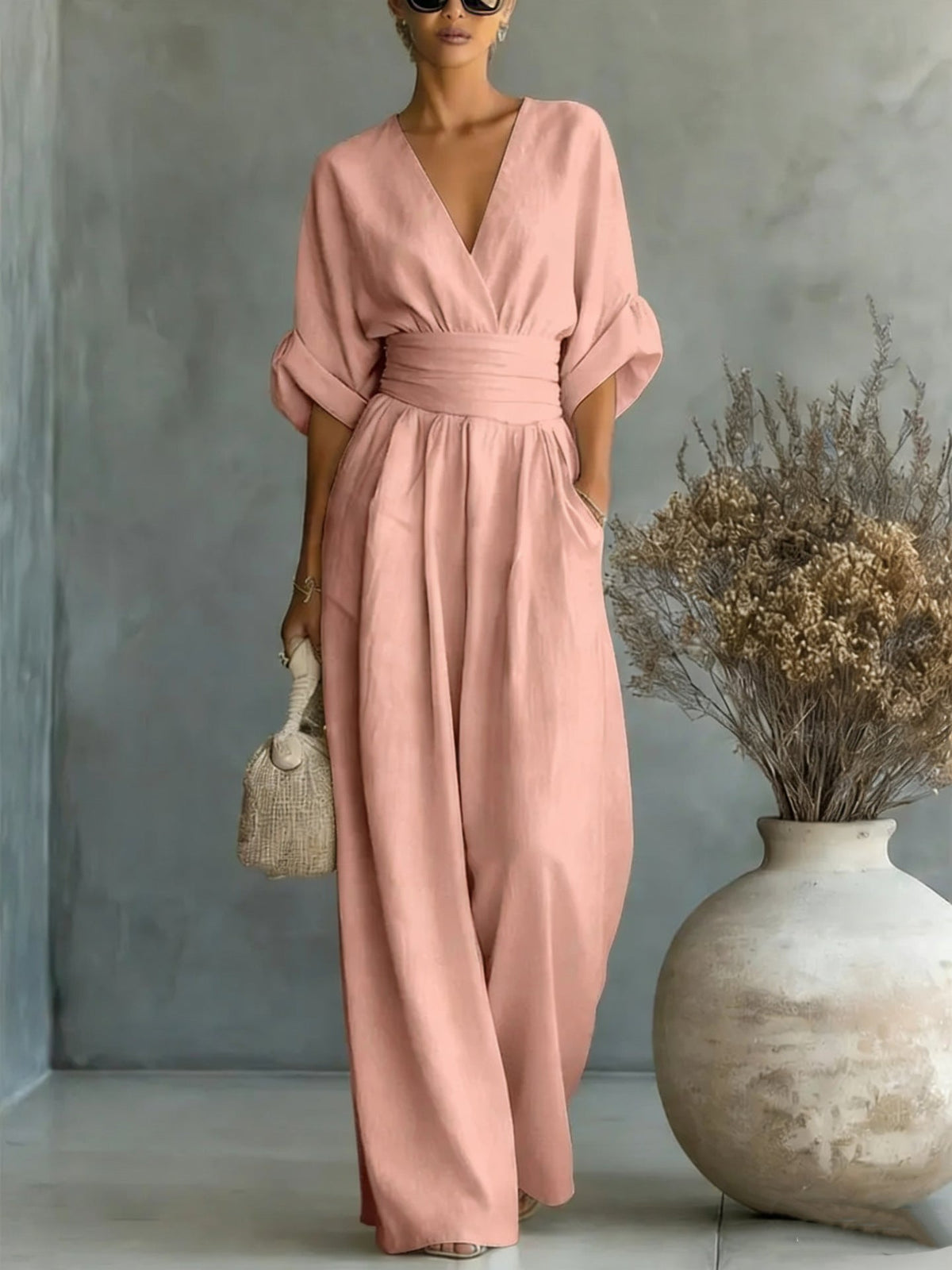 Olive green jumpsuit styled for a chic daytime appearance, perfect for a sophisticated look.