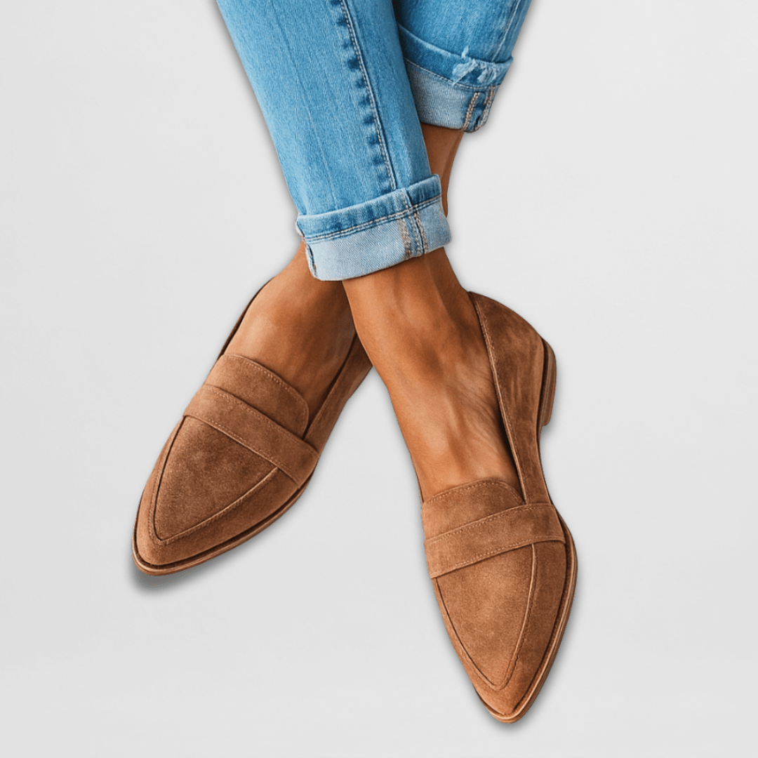 Close-up detail of the soft suede texture and elegant stitching on the top of the loafers.