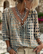 Pink boho blouse, styled for a relaxed holiday look, paired with comfortable trousers.
