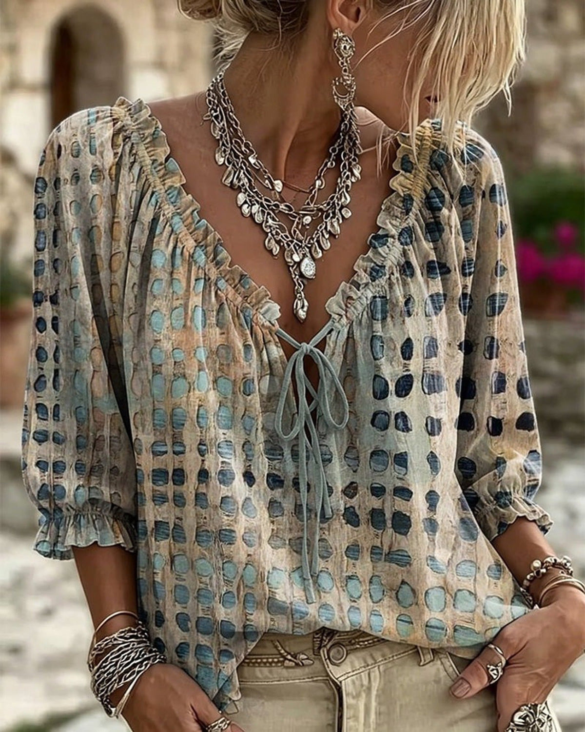 Pink boho blouse, styled for a relaxed holiday look, paired with comfortable trousers.