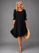 Woman enjoying a casual day, showcasing the comfortable fit of the Nora elegant midi dress in black.