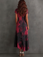 Back view of the purple abstract print maxi dress, highlighting its graceful drape and long silhouette.