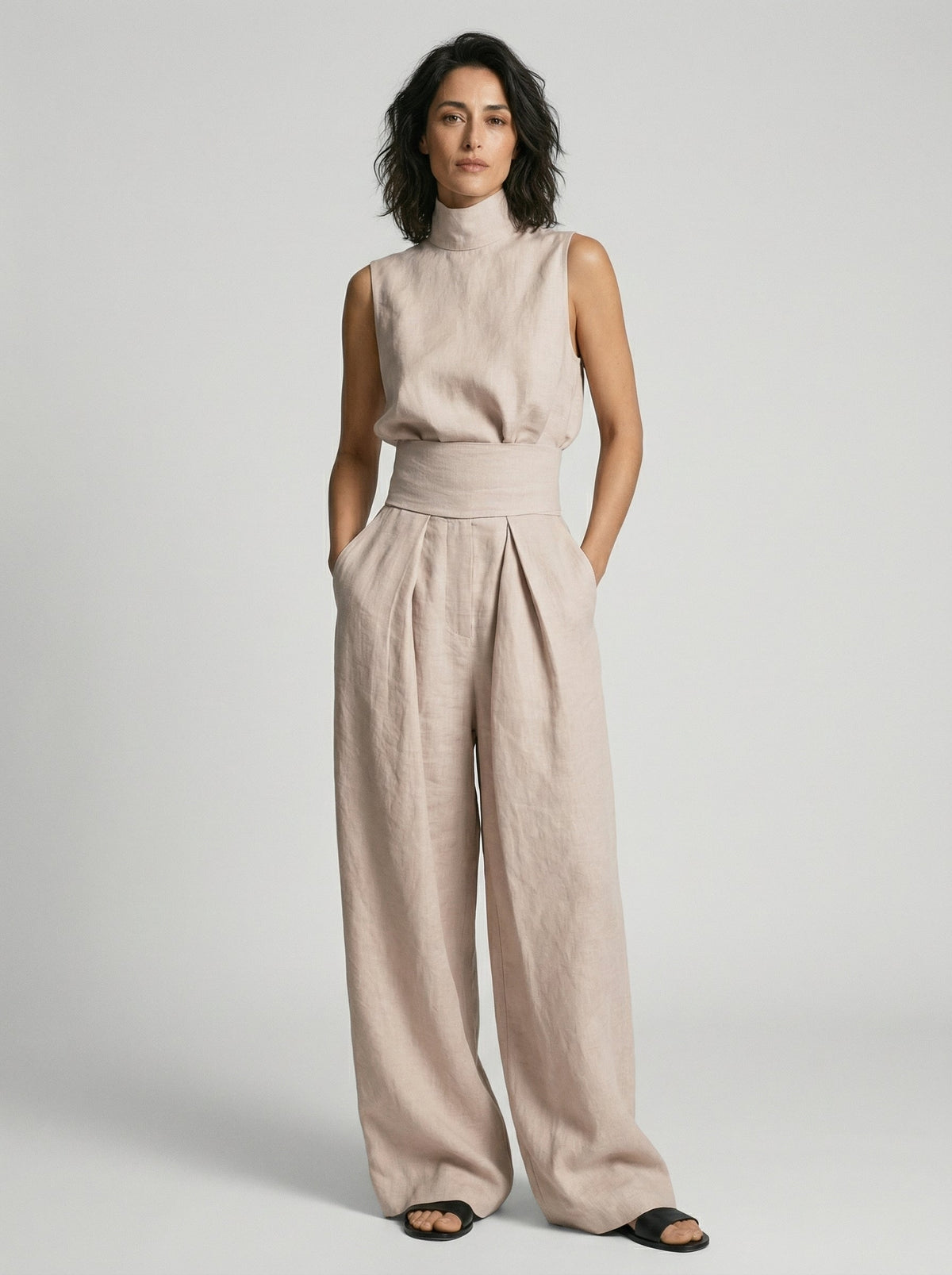 Model walking in olive green wide-leg trousers, showcasing the fluid movement and comfort of the design.
