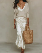 Back view of a white ribbed knit sweater, emphasizing the clean lines and quality stitching.