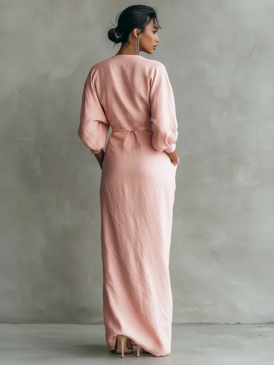 Close-up detail of the twisted waist knot on the elegant black maxi dress, showing its sculpted design and flattering fit.