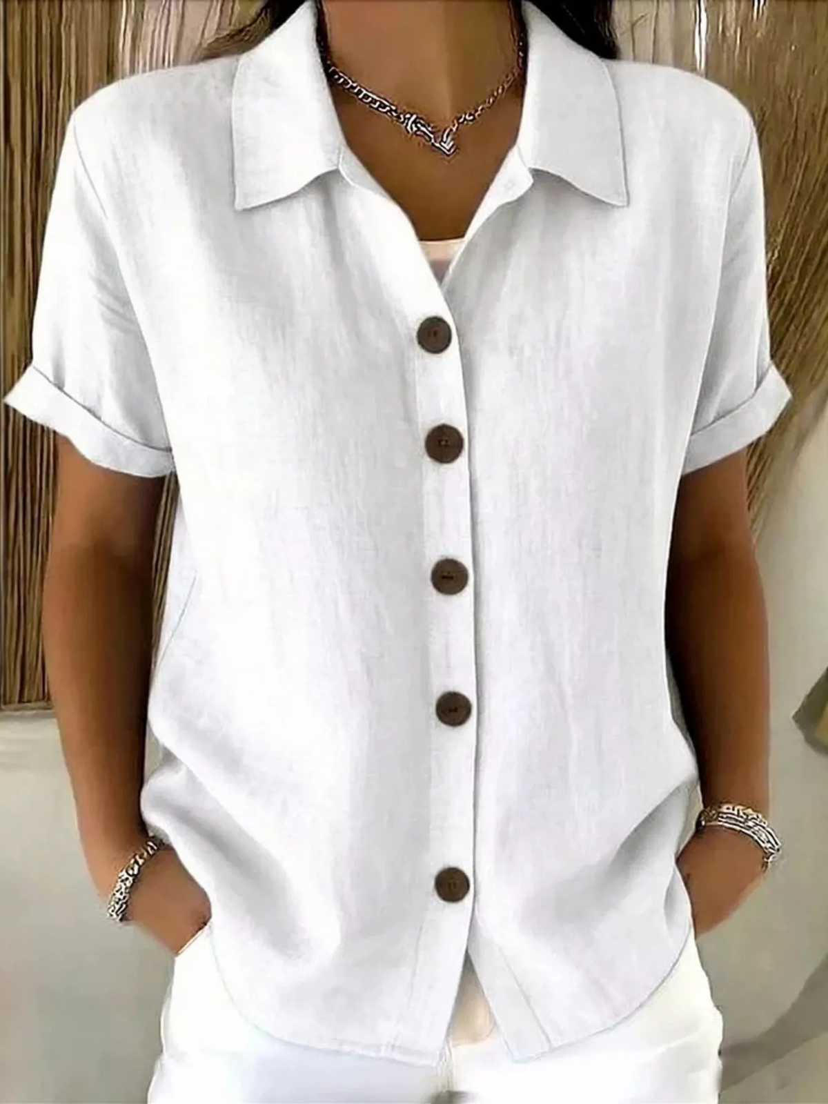 Back view of the versatile Daphne short-sleeve shirt in cream, highlighting its clean silhouette.