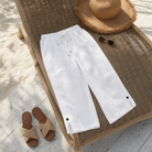 Full front view of white cotton-linen capri trousers, highlighting the clean drawstring waist.