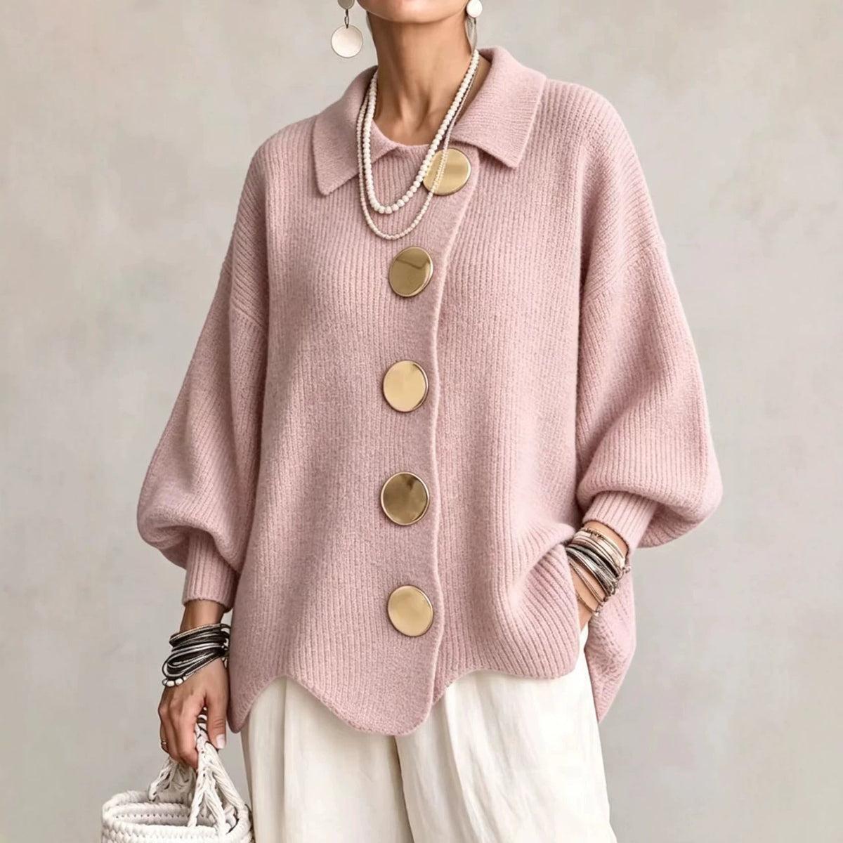 Texture shot of the soft ribbed knit fabric of the pink oversized sweater, highlighting its quality.