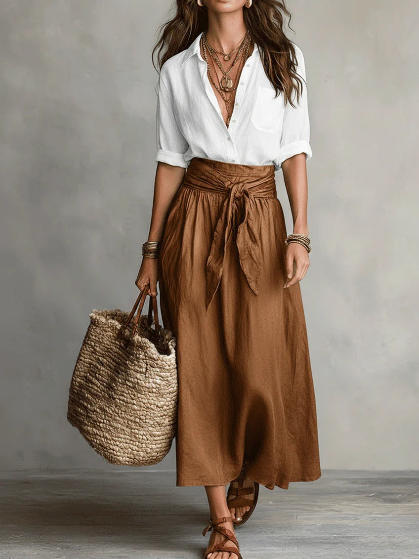 Back view of the versatile olive green skirt, emphasizing the smooth fabric and midi length.