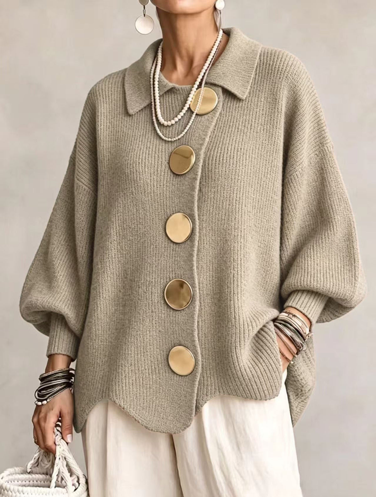 Back view of the khaki ribbed knit sweater, demonstrating the generous fit and sleeve design.