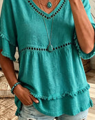 Flat lay of the entire collection of V-neck blouses in various colors, ready for effortless styling.