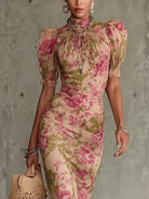 Close-up detail of the delicate ruffled puff sleeves and high neckline of the elegant floral maxi dress.