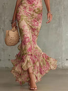 Side profile of a woman showcasing the fitted waist and flowing mermaid skirt of the romantic floral maxi dress.