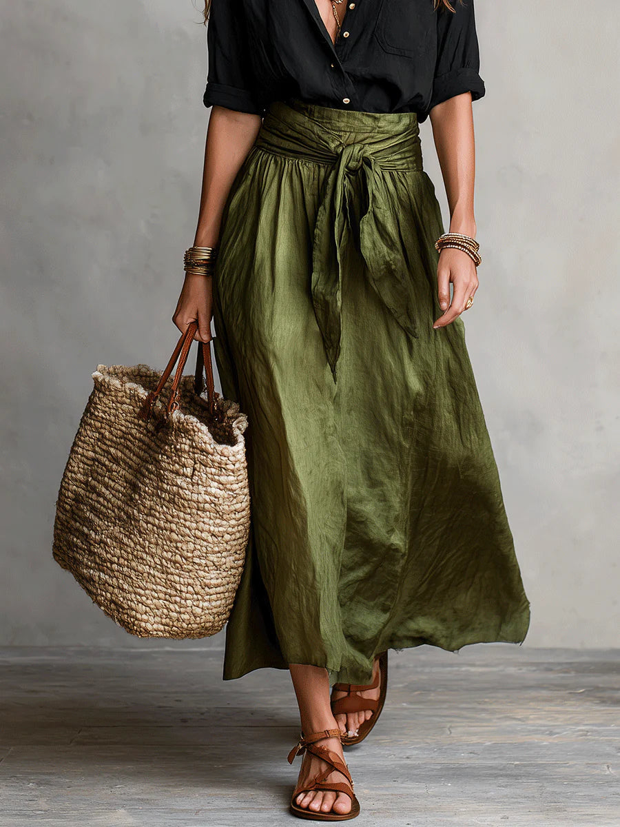 Stylized shot of the high-waisted skirt dressed up with accessories, suitable for an evening event.